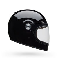 Black motorcycle helmet with clear visor on a white background