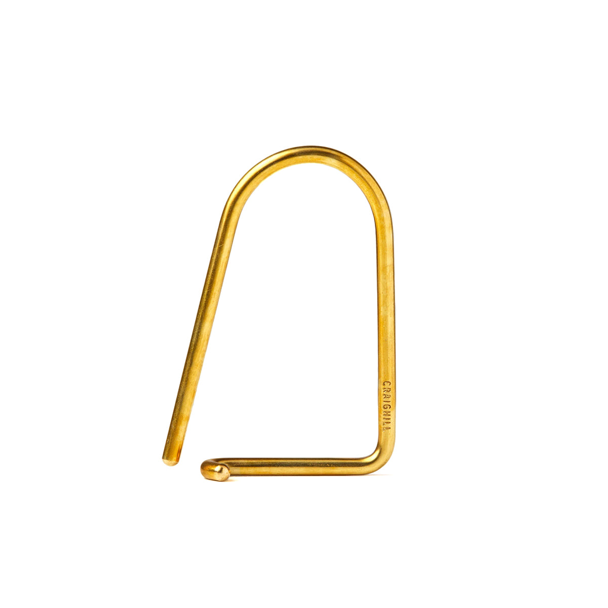 Brass U-shaped metal hook on a white background