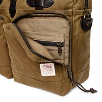 Brown briefcase with a visible Filson label on a white background