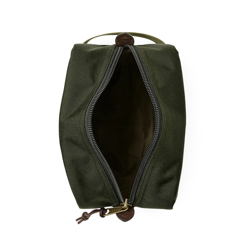 Green toiletry bag with open zipper on a white background