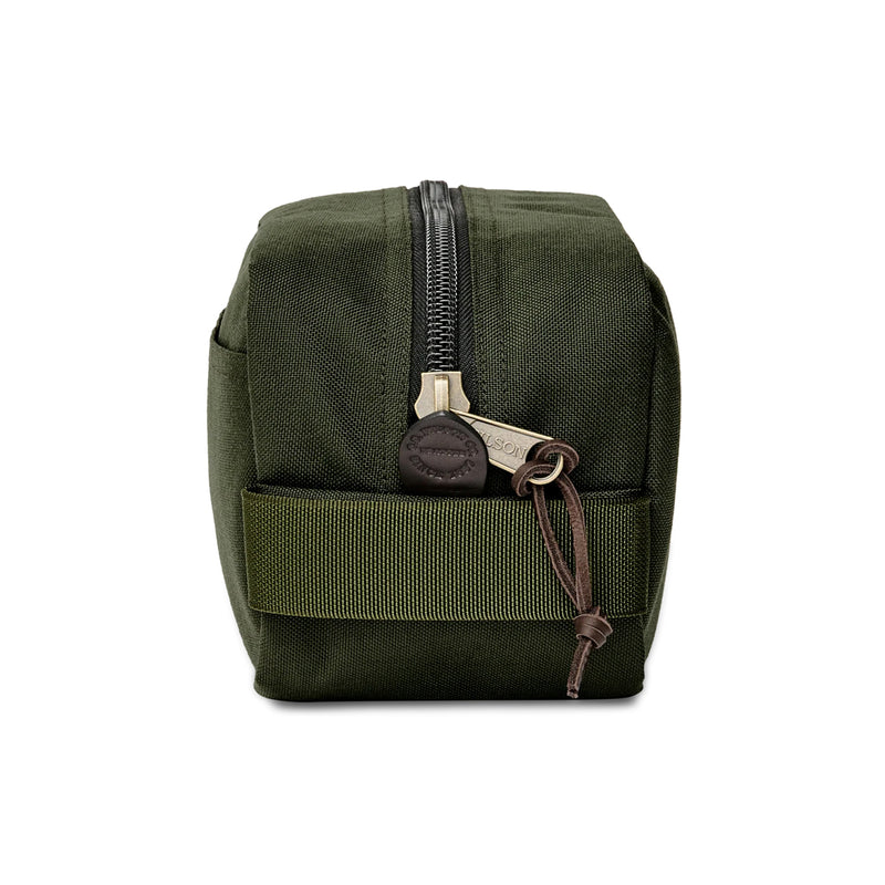 Green toiletry bag with a keychain on a white background