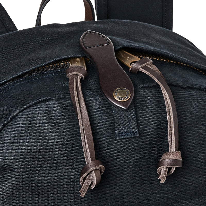 Black backpack with leather straps and brand logo on a white background