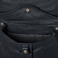 Close-up of a black pocket on backpack with button details on a white background