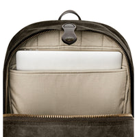 Backpack with a compartment holding a white laptop on a white background