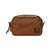 Brown toiletry bag with Filson logo on a white background
