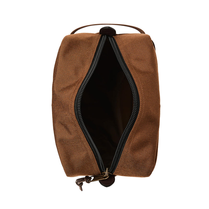 Brown toiletry bag with open zipper on a white background