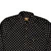 Black shirt with white polka dot pattern on a white background