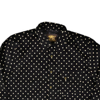 Black shirt with white polka dot pattern on a white background