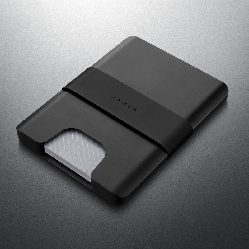 Black cardholder with 'JAMES' branding on a metallic gray background