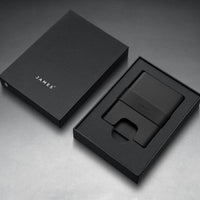 Black wallet and cardholder set with 'JAMES' branding on a gray background