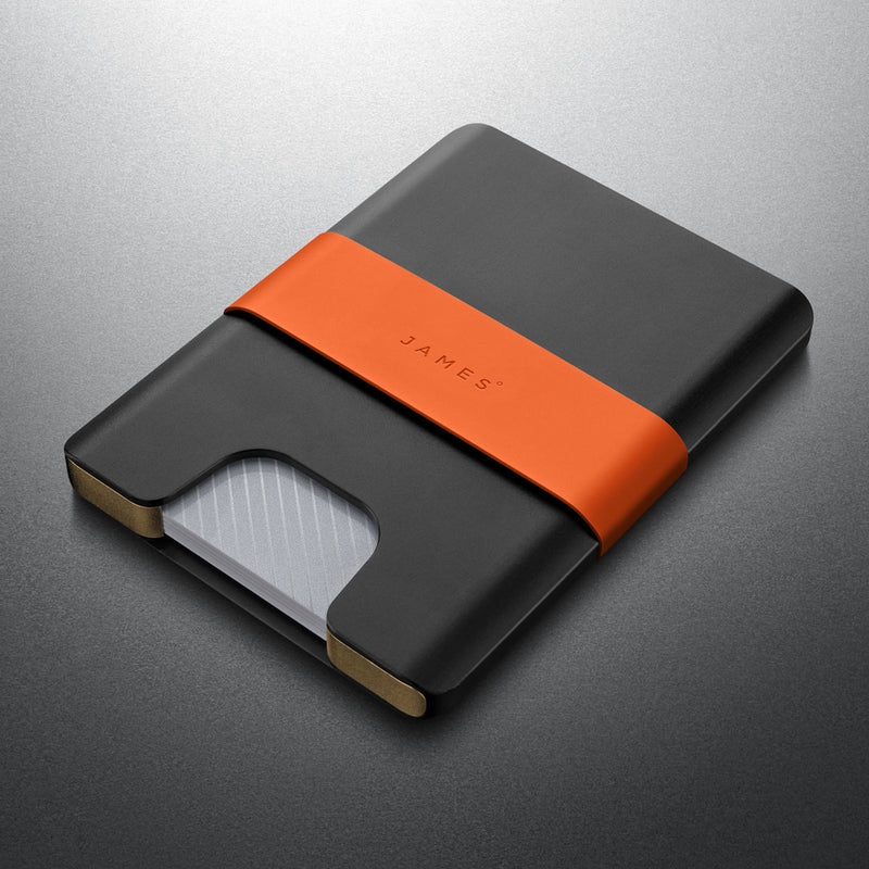 Black and orange cardholder with 'JAMES' branding on a gray background