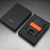 Black cardholder with orange accent in a black box, branded 'JAMES'.