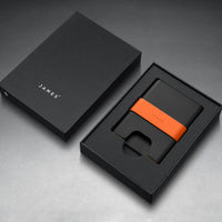 Black cardholder with orange accent in a black box, branded 'JAMES'.