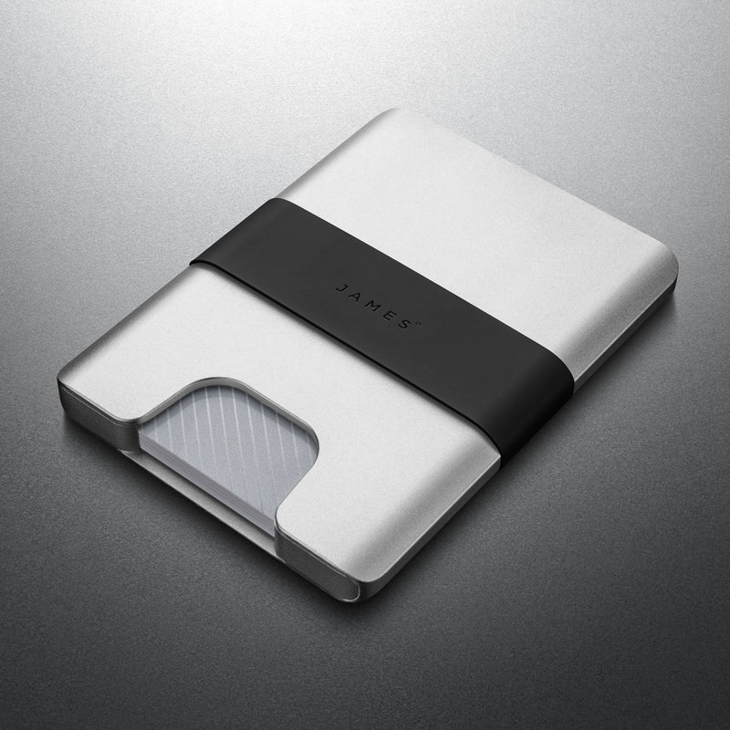 Silver wallet with black strap on a gray background
