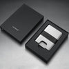 Silver wallet with black strap on a gray background