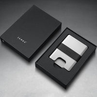 Silver wallet with black strap on a gray background
