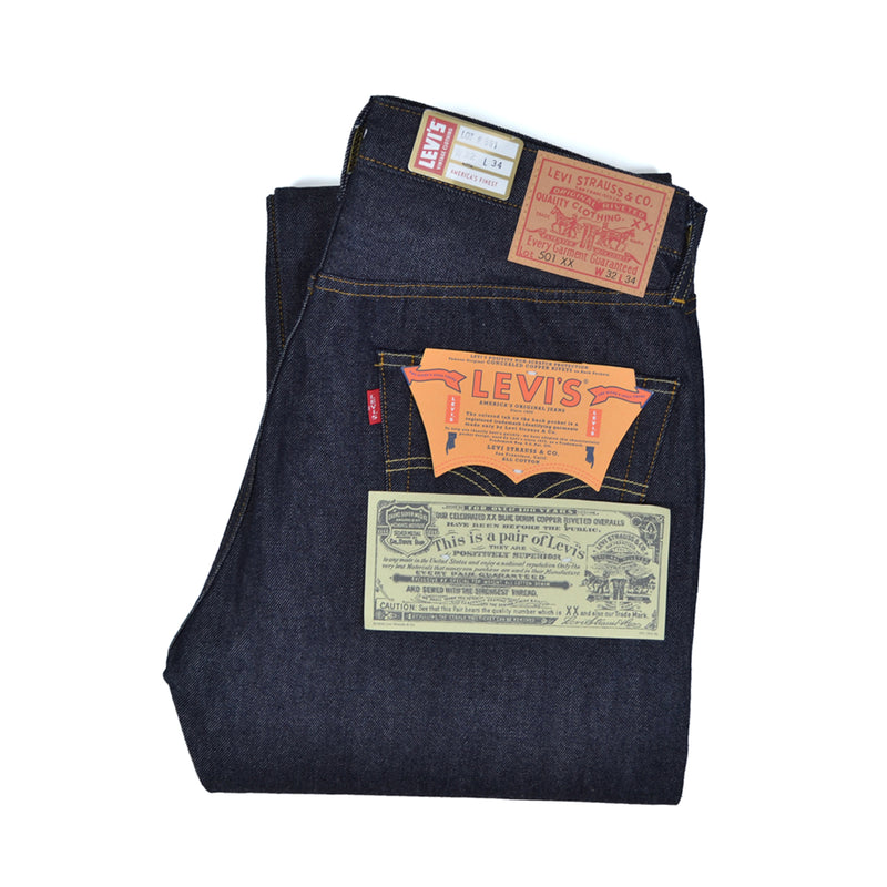Folded Levi's jeans with brand labels on a white background