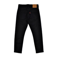 Black jeans with a visible brand tag on a white background
