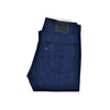 Folded Levi's blue jeans with a brand label on a white background