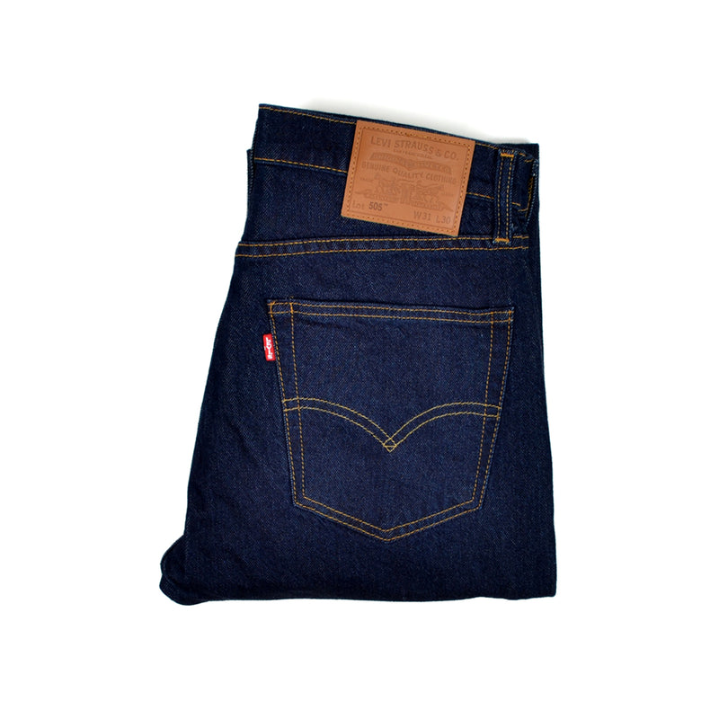 Folded pair of Levi's blue jeans with a Levi's tag on a white background