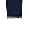Close-up of dark blue denim fabric with a white background