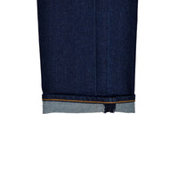 Close-up of dark blue denim fabric with a white background