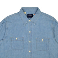 Blue denim shirt with button details on a white background
