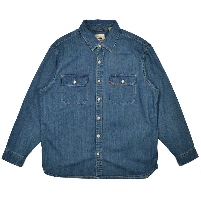 Blue denim shirt with two chest pockets on a white background