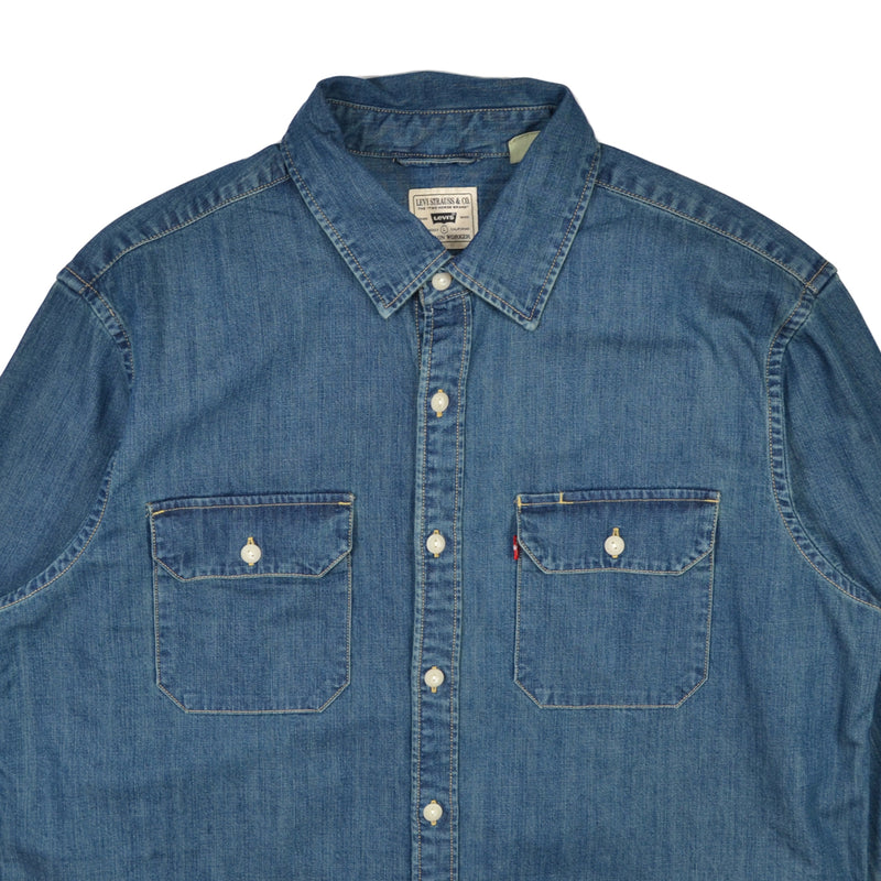 Blue denim shirt with brand label on a white background