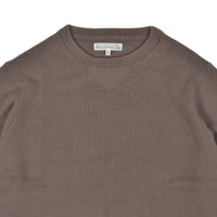 Brown sweater with a visible brand label on a white background