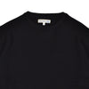 Black sweater with a brand label on a white background