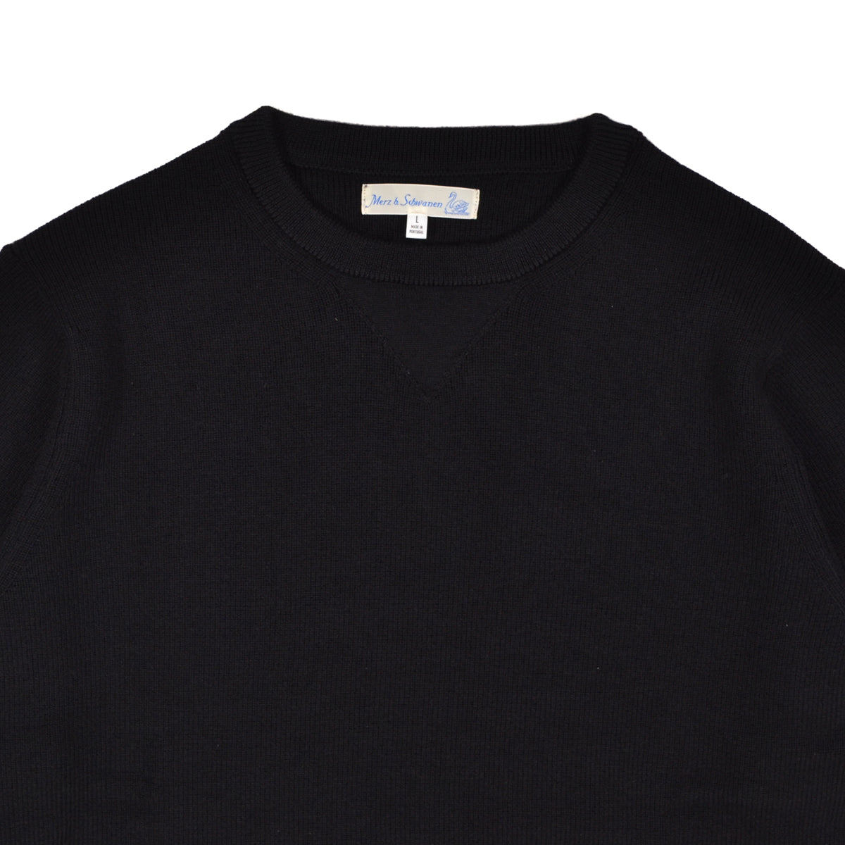 Black sweater with a brand label on a white background