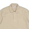 Beige polo shirt with a brand label on a white background