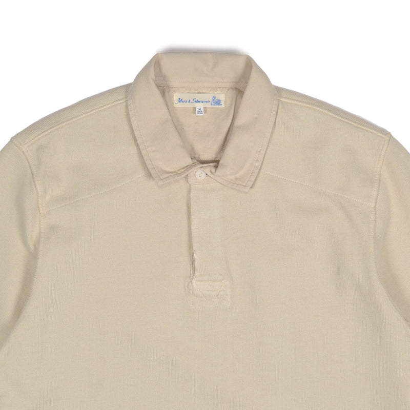 Beige polo shirt with a brand label on a white background