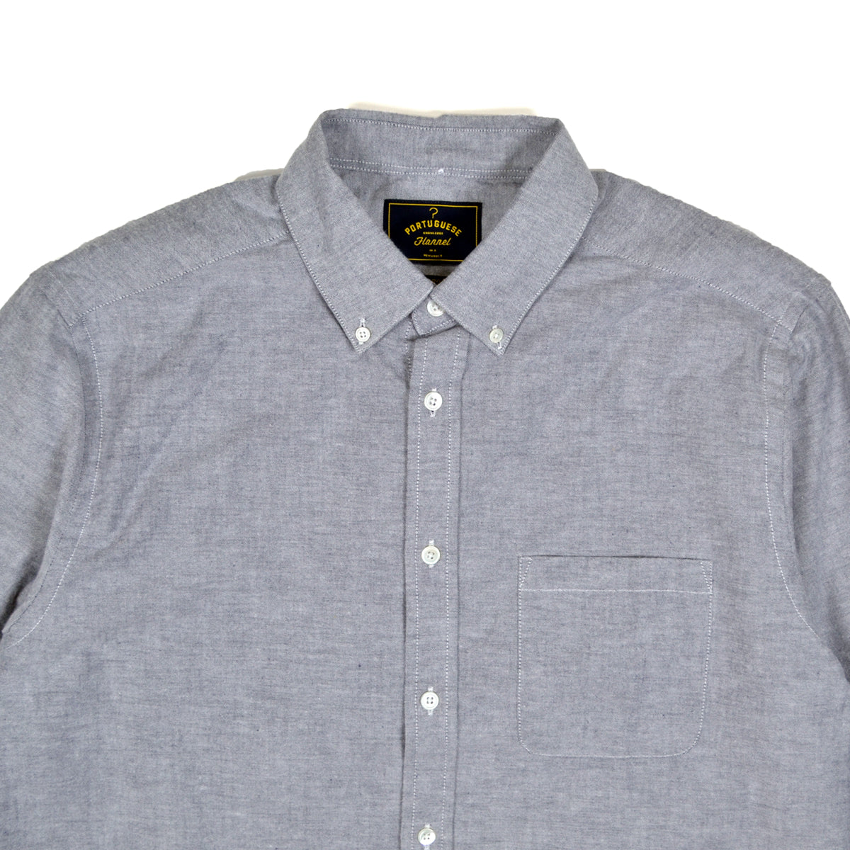 Gray checkered shirt with a brand label on a white background