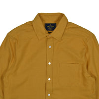 Yellow shirt with a collar and buttons on a white background