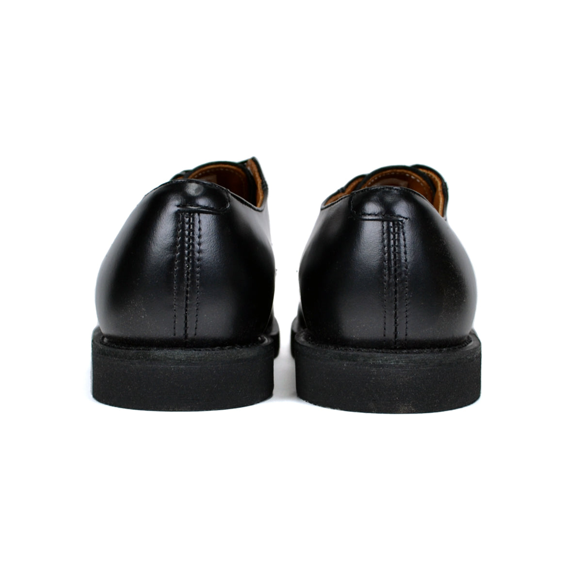 Pair of black leather shoes on a white background