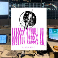 Close up of t-shirt graphic with 'Reserve Supply Space City' design in a retro-tech setting