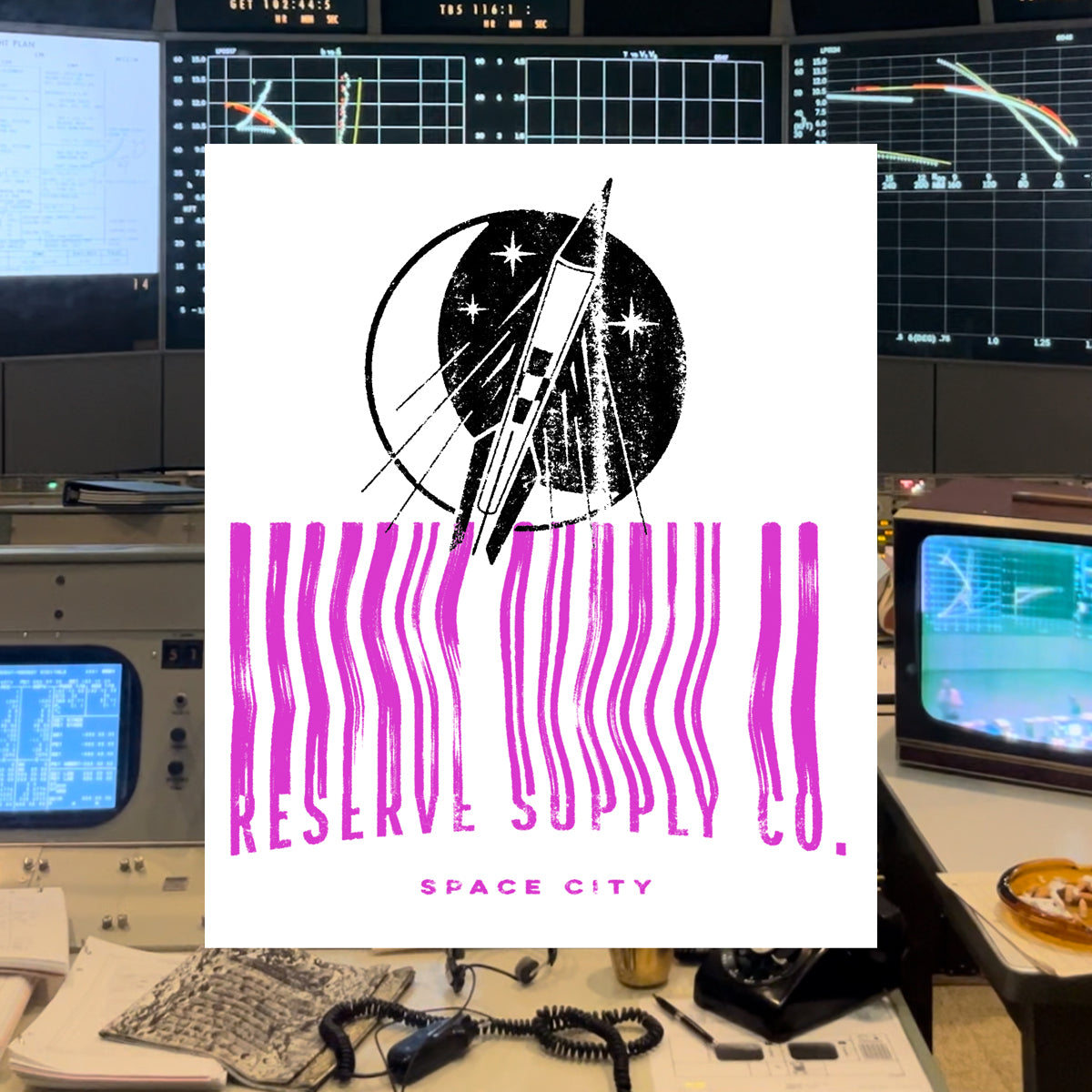 Close up of t-shirt graphic with 'Reserve Supply Space City' design in a retro-tech setting
