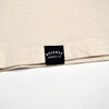 Beige fabric with a black label reading 'Reserve Supply Co' on a white background