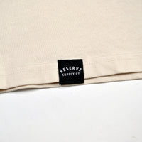 Beige fabric with a black label reading 'Reserve Supply Co' on a white background