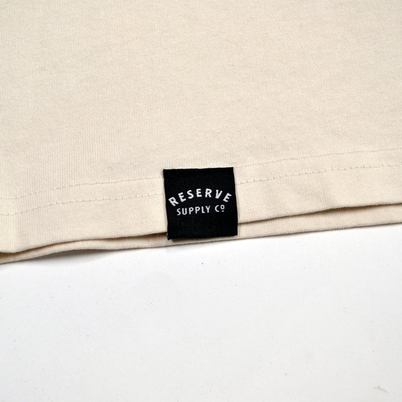 Beige fabric with a black label reading 'Reserve Supply Co' on a white background