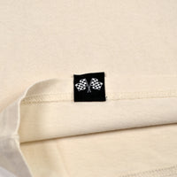 Close-up of a label with checkered flags on a beige fabric background