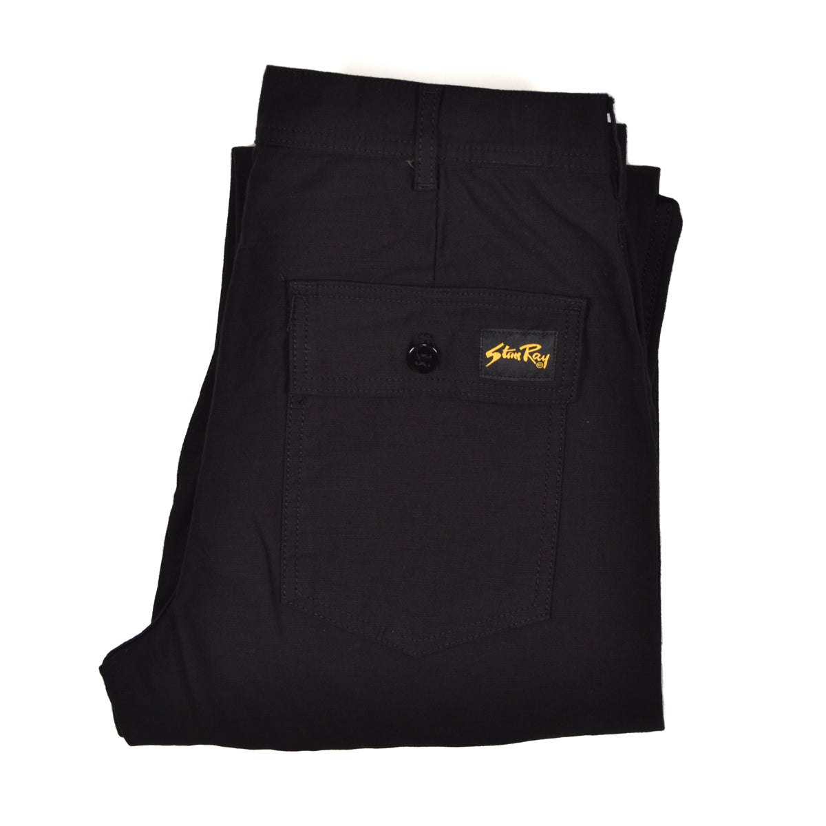 Folded black pants with a brand logo on a white background