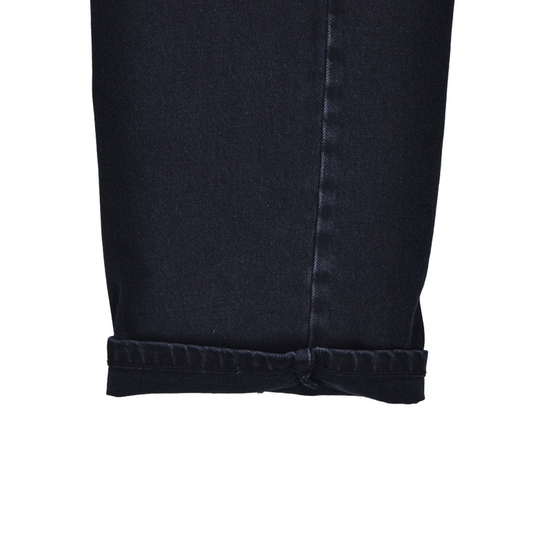 Close-up of a black denim skirt on a white background