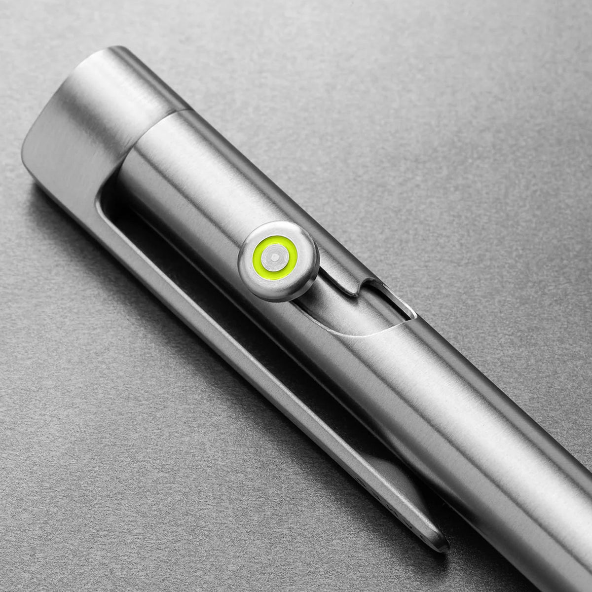 Metallic pen with a green light on a gray background