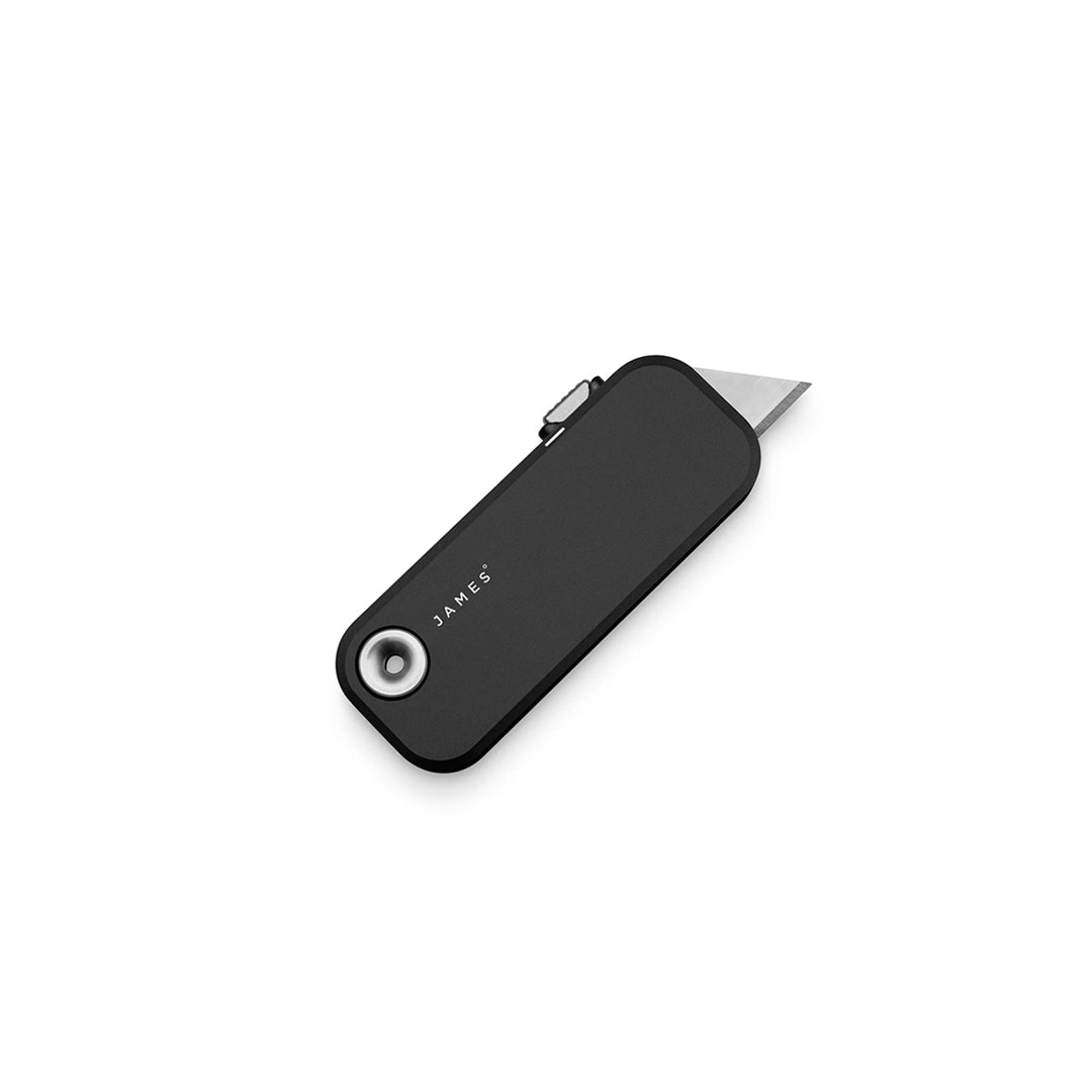 Black utility knife with a silver blade on a white background