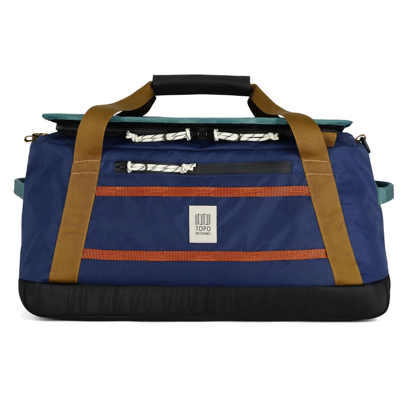 Blue duffel bag with brown straps and a Topo Designs logo on a white background