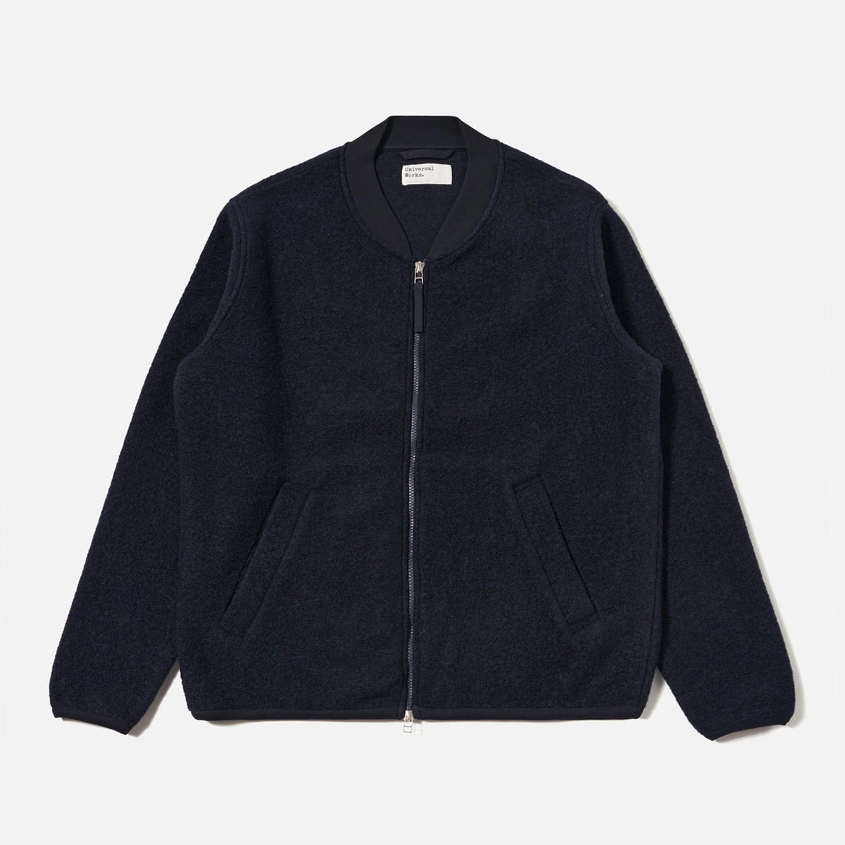 Navy blue zip-up jacket on a light gray background