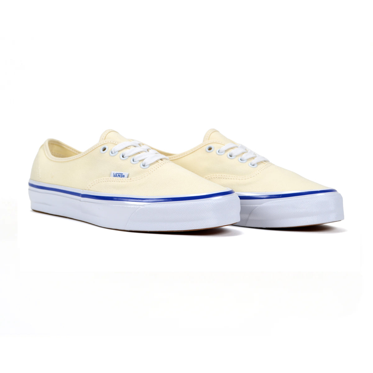 Pair of off-white sneakers with blue soles on a white background